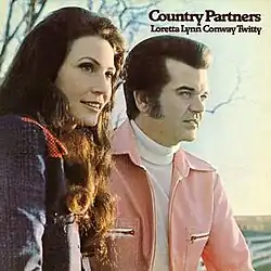 photo of Loretta Lynn and Conway Twitty looking off-camera