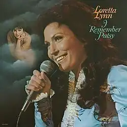 photo of Loretta Lynn with microphone and Patsy Cline in clouds image