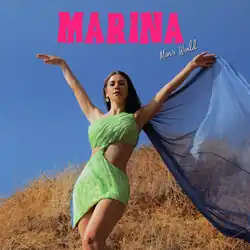 Welsh singer-songwriter Marina Diamandis appears in a sleeveless green dress that partially exposes the sides of her midriff; a blue cape flows in the wind behind her and she stands in a field with the sky in the background. The words "Marina", which was written in a capitalized and bright pink font, and "Man's World", which was written in a white cursive font, appear.