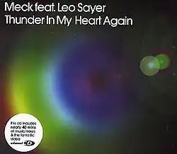A concentric rainbow is imposed over a faded black background. The song title and artist are positioned in the top-left corner in white font.