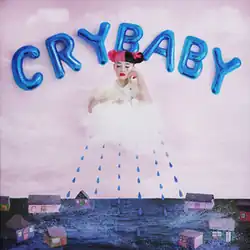 Cover artwork of Melanie Martinez's 2015 album Cry Baby, depicting Martinez emerging from a cloud against a pink sky, with blue balloon letters spelling "CRY BABY" above her and blue raindrops falling over a small row of houses below.