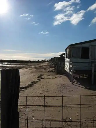 Looking north along the beachfront shacks