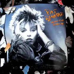 photo of a Pat Benatar album cover among trash papers with cover showing Benatar holding head with hands