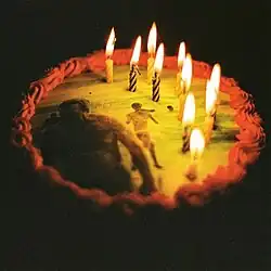 A birthday cake with a beach scene on it