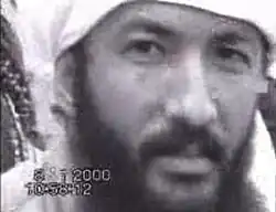Black-and-white still image of al-Adel