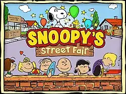 Artwork used on the game's title screen. It depicts six Peanuts characters (from left to right: Peppermint Patty, Sally Brown, Charlie Brown, Lucy Van Pelt, and Schroeder) behind a brick wall in front of a street fair. Above the kids is the game's logo together with Snoopy and Woodstock.