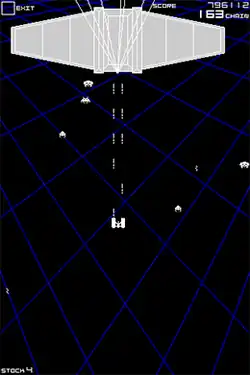 A vertical rectangular video game screenshot that is a digital representation of a battle between aliens and a flying space ship against a black background with a moving blue grid-like pattern. A small white space ship is at the center firing upward. A large blocky light-grey space ship with long tapered wings is at the top of the screen while white crustacean-themed aliens fly around.