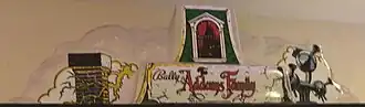 Topper of The Addams Family pinball machine with clouds and logo