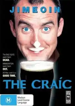 Jimeoin smiling, a pint of Guinness in front of him, a "beer moustache" on his top lip and nose.