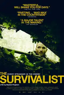 A bearded man peers out from dense green foliage while holding a rifle pointed across the image to the left; the title “The Survivalist” appears at the bottom.