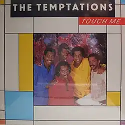 The band posing and smiling, surrounded by Piet Mondrian-style rectangles
