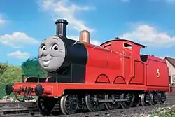 A red standard-gauge mixed-traffic steam locomotive with a grey face on his smokebox door. A yellow number 5 is painted on the coal tender.