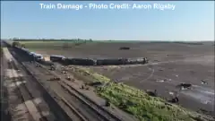 An aerial photograph of a field, with a tipped-over train car being visible.