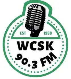 Old time radio microphone in a green circle