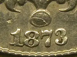 Fraction d'une pièce de monnaie avec le nombre 1873.