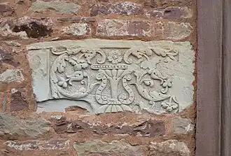 Relief floral en tufeau de Tourraine encastré dans le mur du donjon, provenant d'un château tourangeau.