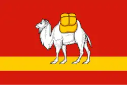 Drapeau à fond rouge avec une ligne jaune horizontale et un chameau blanc.