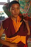 Le jeune batteur tibétain avec son tambour sur l'épaule se prépare à jouer le jour du Bodhisattva!
