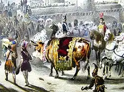 Image colorée figurant un bœuf entouré de cavaliers et d'hommes avec des massues et des coiffes à plumes