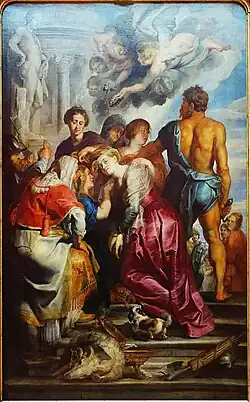 Une femme est préparée avant sa décapitation : une femme lui bande les yeux et deux autres dégagent sa nuque de ses cheveux. Des anges descendent du Ciel pour lui apporter une couronne de fleurs.