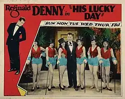 affiche couleur comprenant une photo colorisée d'un homme en costume entouré de danseuses de revue