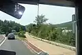La piste cyclable qui a remplacé la voie du train bleu en bordure de la route à la hauteur de l'arrêt Usine Guimet (photo prise depuis un bus de la ligne 40)