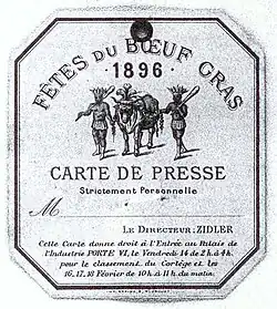 Papier octogonal avec au centre la figure d'un bœuf entouré par deux torse-nus tenant une massue et coiffés de plumes