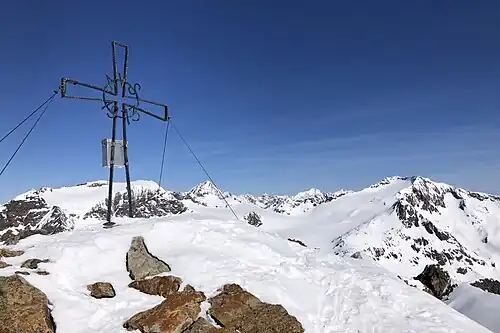 Gipfelkreuz des Botzer, hinten links die Sonklarspitze, Mitte der Wilde Pfaff, rechts der Wilde Freiger
