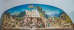 Weihnachtskrippe mit 50 Figuren, die Rudolf Moroder fūr seine Braut als Hochzeitsgeschenk 1910 geschnitzt hat. Die Krippe wurde von Josef Moroder Lusenberg, sein Onkel, bemahlt.